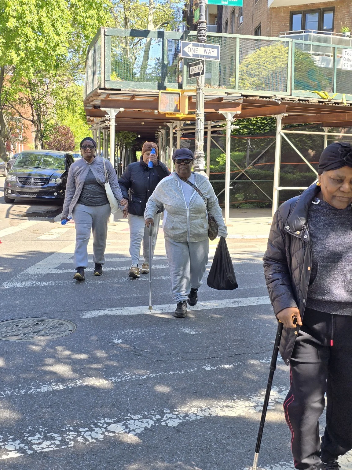Community members walking past a row of international flags