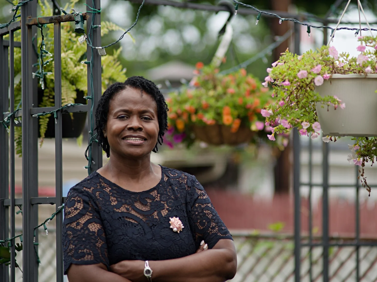 Sherma Apparicio-D’Afflitto, founder of Rise. Walk. Renew., standing in a garden setting