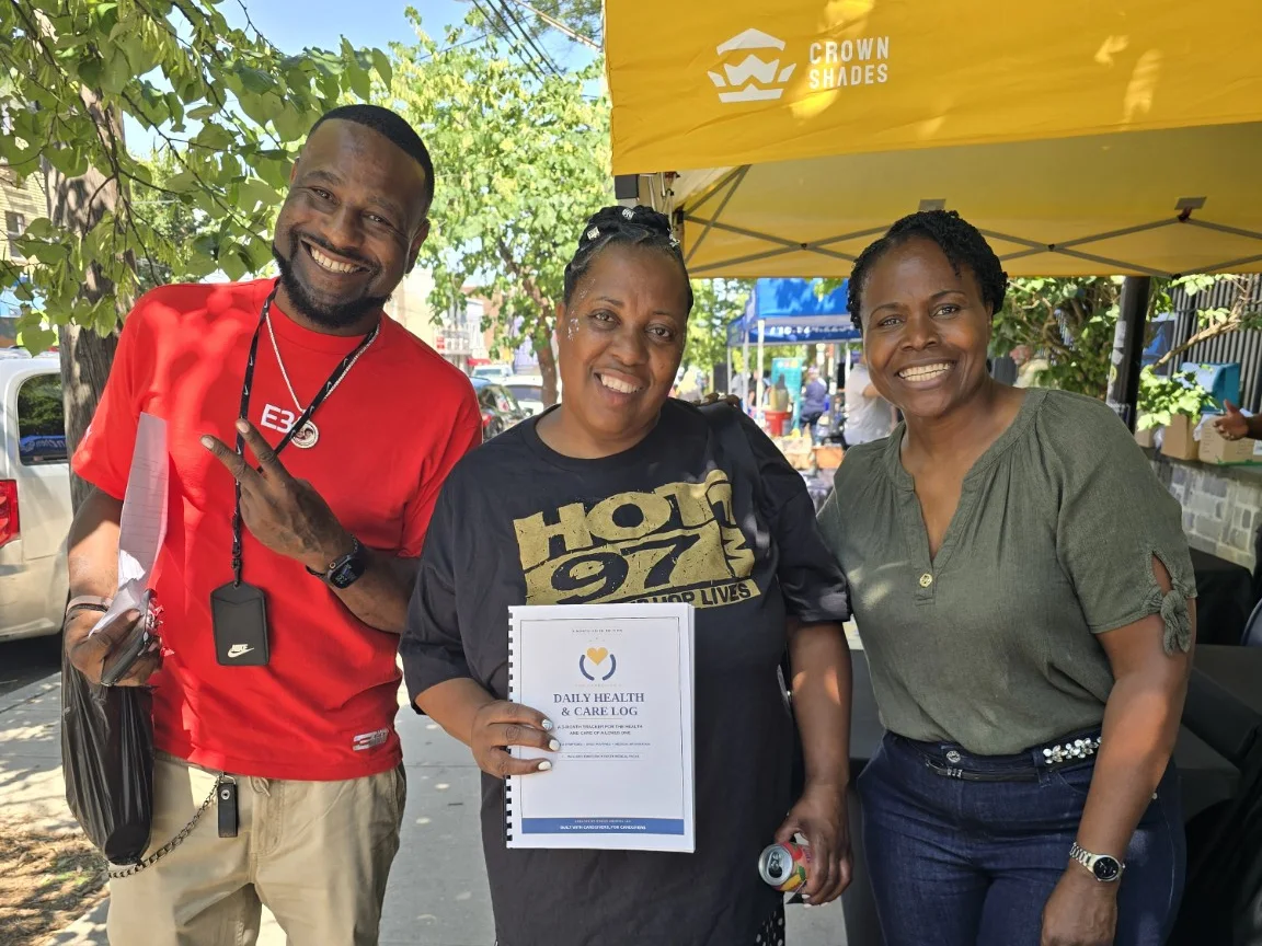 A family receives a Daily Health and Care Log at a community health fair