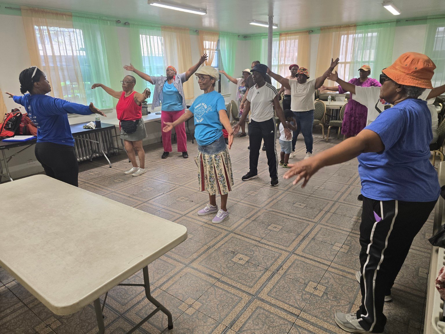 A coach leads a coordinated indoor movement class