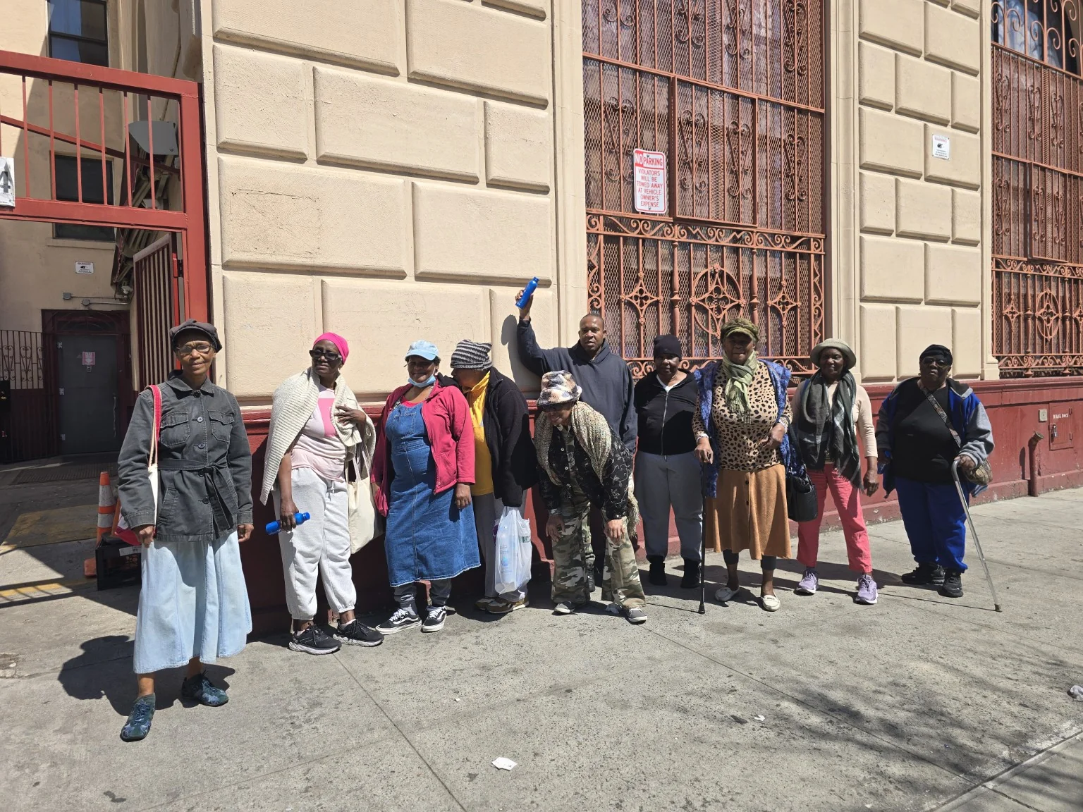 The Tuesday community wellness group posing together outside its meeting place